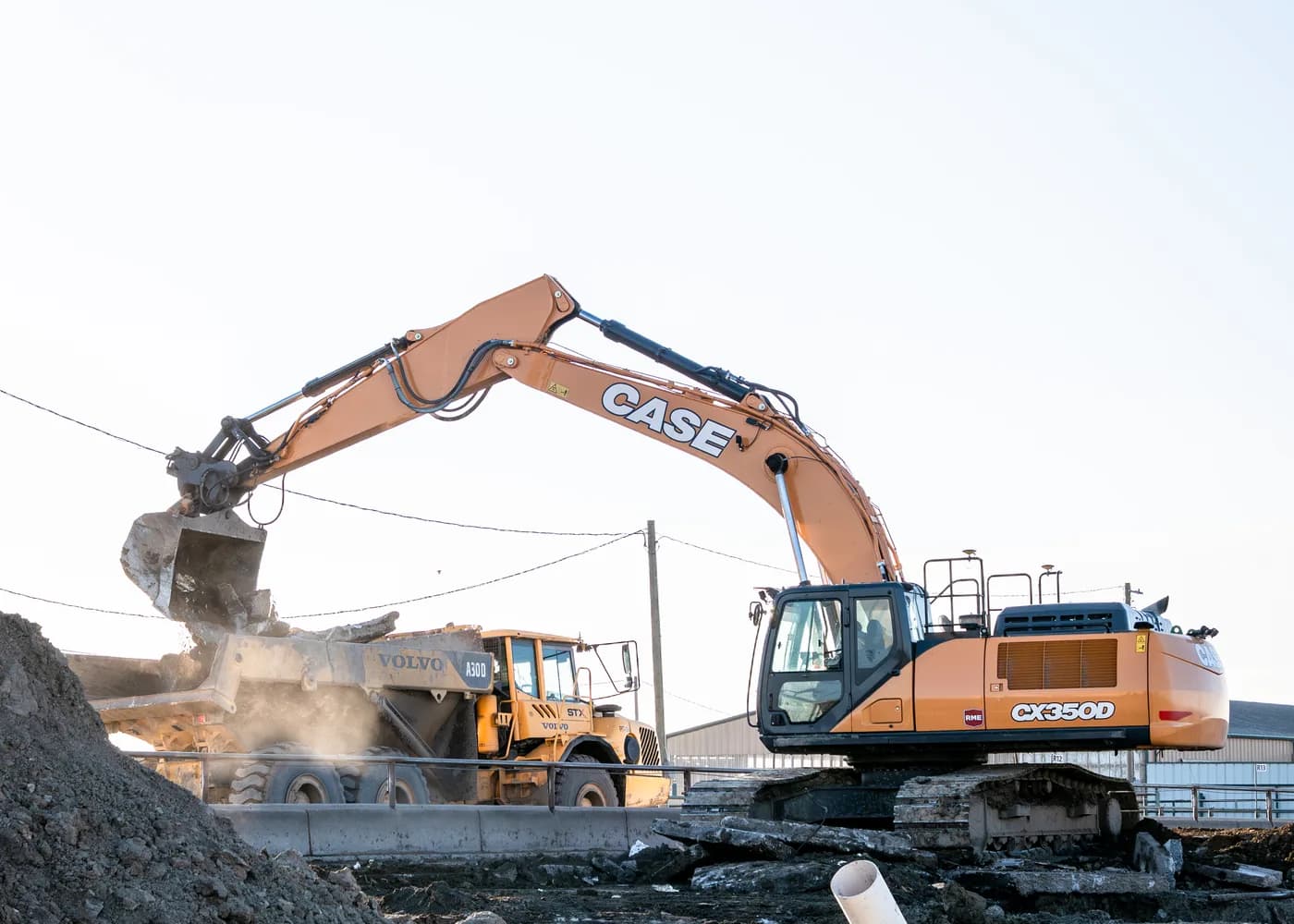 Subterrain demolition excavator loading material into a Volvo articulated dump truck