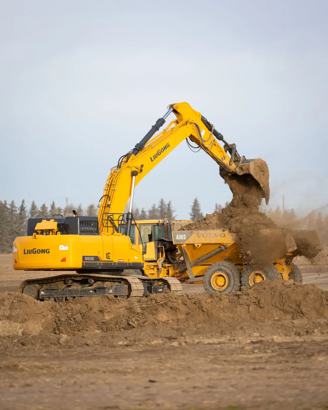 Subterrain excavator loading an articulated dump truck